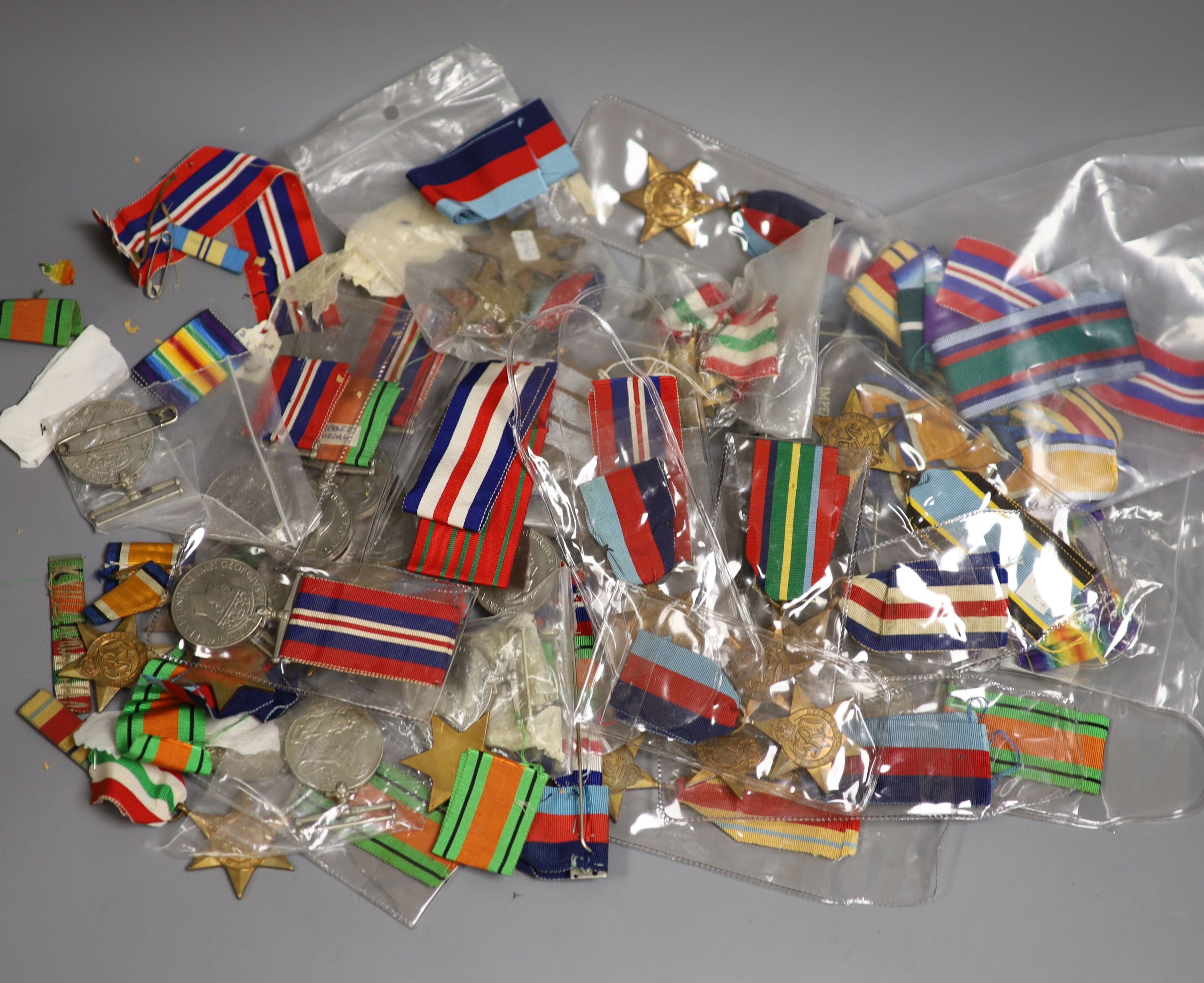 A large collection of unnamed WWII medals and spare ribbons and a cased QEII Imperial Service Medal to John Henry Hope